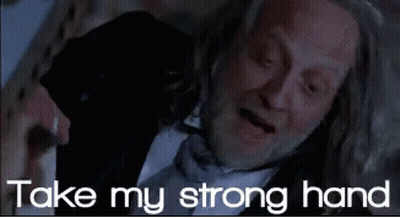 Man In Suit And Tie Laying Down Saying Take My Strong Hand GIF