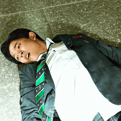 Man in Suit and Tie Laying on Floor