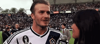 Man In Suit And Tie Looking At Another Man In Crowd GIF