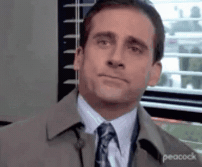 Man In Suit And Tie Looking At Camera GIF