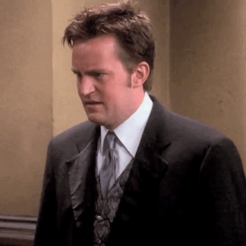 Man In Suit And Tie Looking At Camera GIF