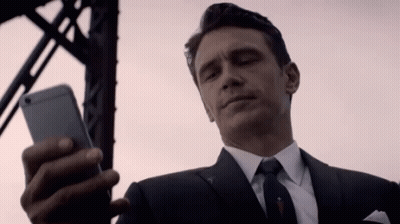 Man In Suit And Tie Looking At Phone GIF
