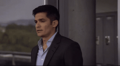 Man In Suit And Tie Looking Out Window GIF