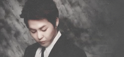 Man In Suit And Tie Looks At Camera GIF
