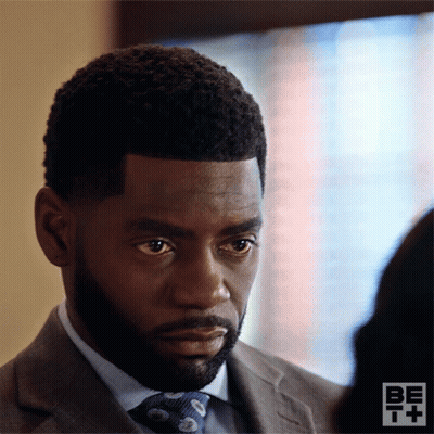 Man In Suit And Tie Looks At Other GIF