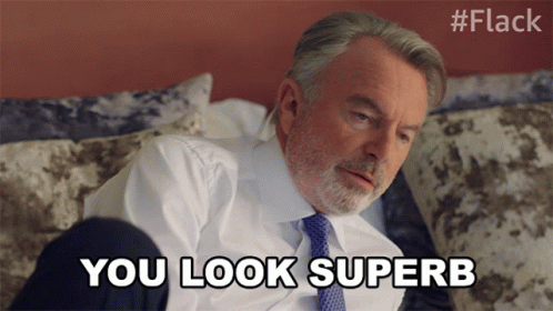 Man In Suit And Tie Lying On Bed Says You Look Superb GIF