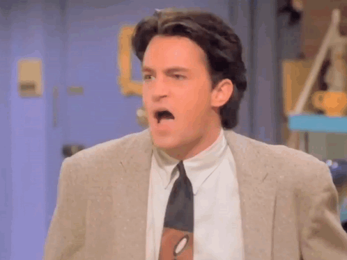 Man In Suit And Tie Making A Face GIF