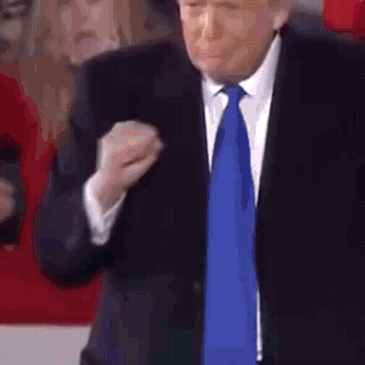 Man In Suit And Tie Making Fist GIF