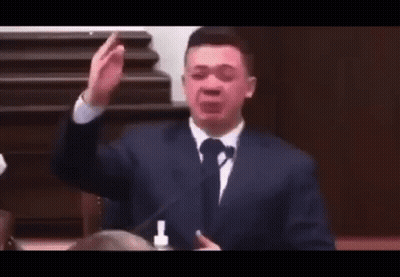 Man In Suit And Tie Making Funny Face At Microphone GIF