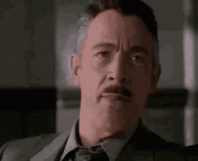Man In Suit And Tie Making Funny Face GIF