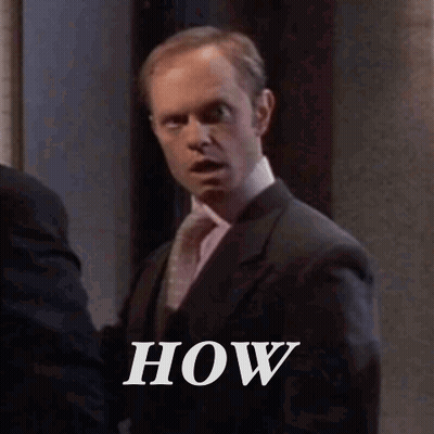 Man In Suit And Tie Next To Another Man GIF