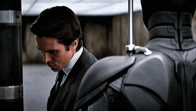 Man In Suit And Tie Next To Gray Robot GIF