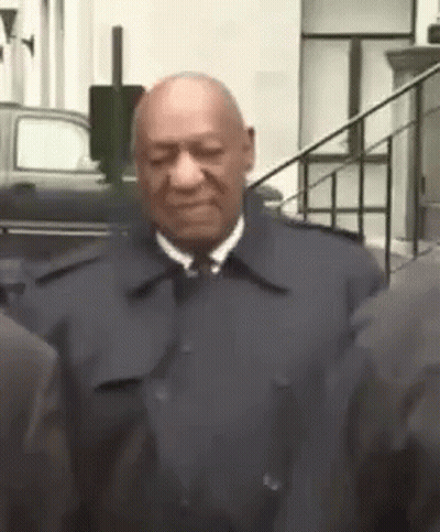 Man in Suit and Tie Next to Group