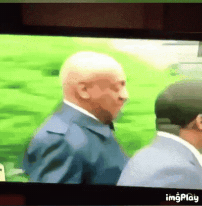 Man In Suit And Tie Next To Man In Hat GIF
