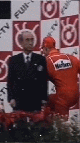 Man In Suit And Tie Next To Man In Red Marlboro Uniform GIF