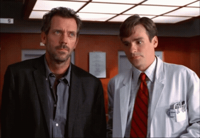 Man In Suit And Tie Next To Man In White Coat GIF