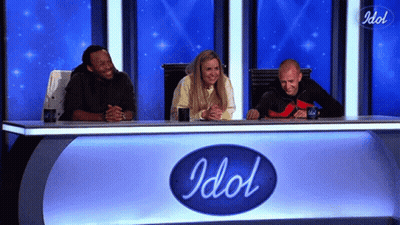 Man In Suit And Tie Next To Woman In Blue Uniform GIF