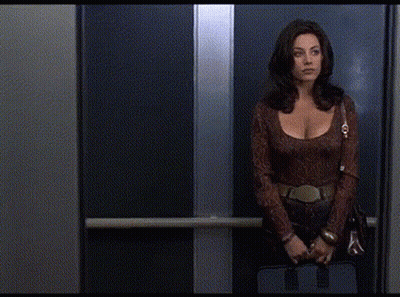 Man In Suit And Tie Next To Woman In Brown Dress GIF