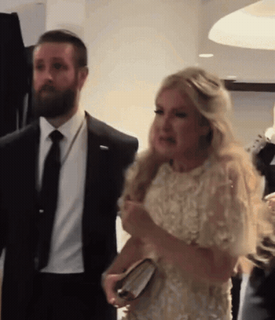 Man In Suit And Tie Next To Woman In Dress GIF