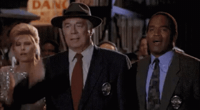 Man In Suit And Tie Next To Woman In Dress GIF