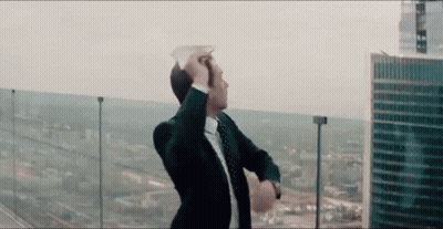 Man In Suit And Tie On Balcony Overlooking City GIF