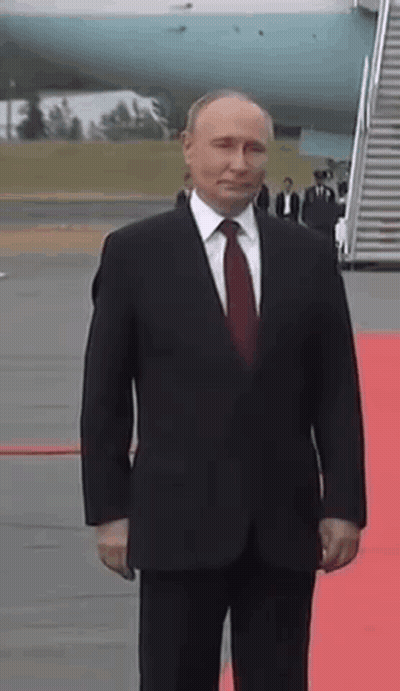 Man In Suit And Tie On Red Carpet By Plane GIF