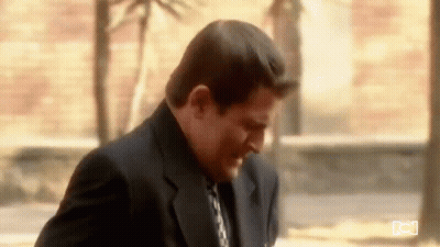 Man In Suit And Tie On Sidewalk GIF