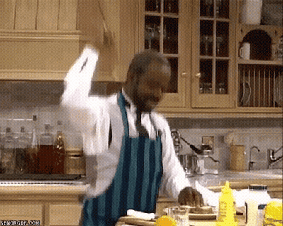 Man In Suit And Tie On Stage With Blue Curtain GIF