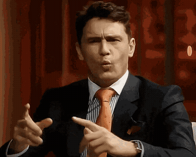Man In Suit And Tie Pointing GIF
