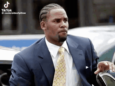 Man In Suit And Tie Posing By Car GIF