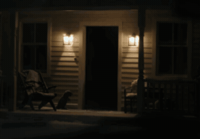 Man In Suit And Tie Projected Onto Door GIF