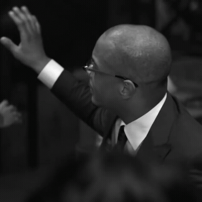 Man In Suit And Tie Raising Hand GIF