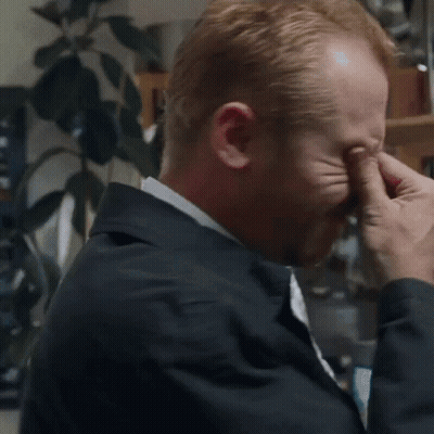 Man In Suit And Tie Rubbing Eyes GIF