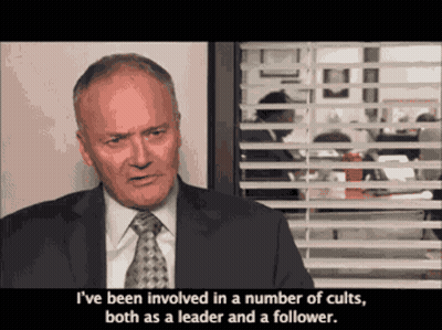 Man In Suit And Tie Saying Cults GIF