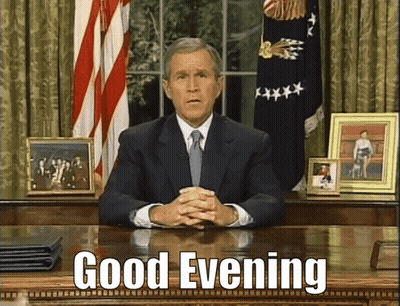 Man In Suit And Tie Saying Good Evening GIF