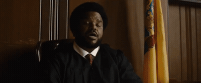 Man In Suit And Tie Saying I'll Allow With Flag GIF