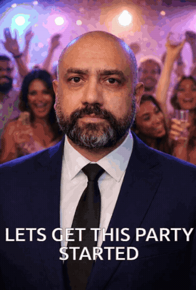 Man In Suit And Tie Saying Let's Get This Party Started GIF