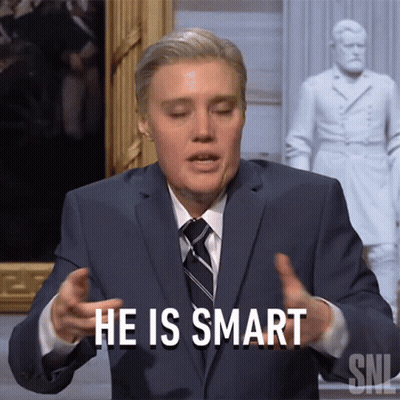 Man In Suit And Tie Saying Smart Before Statue GIF