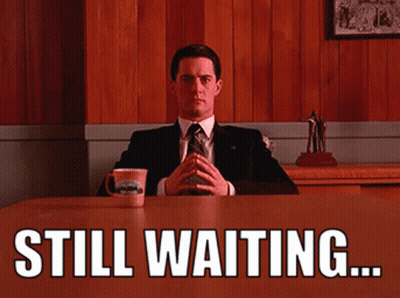 Man In Suit And Tie Saying Still Waiting GIF