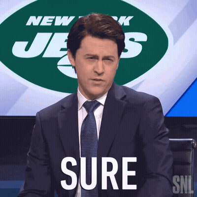 Man in Suit and Tie Saying Sure in Front of Jets Logo