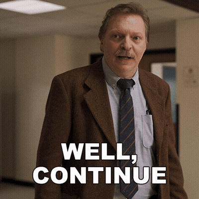 Man In Suit And Tie Saying Well Continue GIF