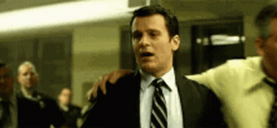 Man In Suit And Tie Saying Whaaaaat Into Microphone GIF