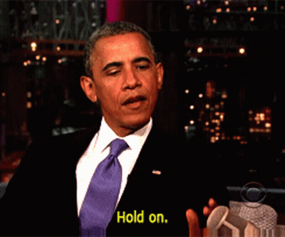 Man In Suit And Tie Saying Yellow Hold On GIF