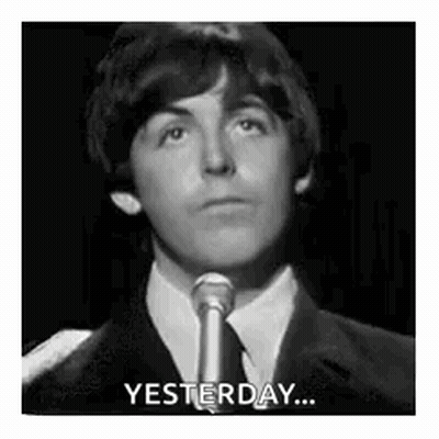 Man In Suit And Tie Saying Yesterday At Microphone GIF