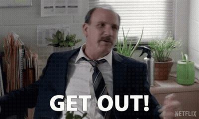 Man In Suit And Tie Says Get Out Netflix Ad GIF