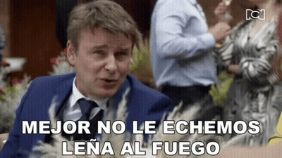 Man In Suit And Tie Says Mejor No Le Echamos Lena Al Fuego GIF