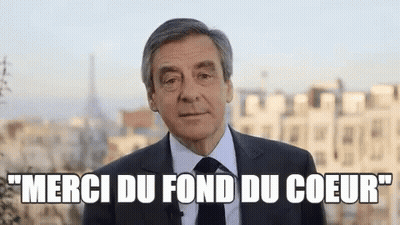 Man In Suit And Tie Says Merci Du Fond Du Coeur GIF