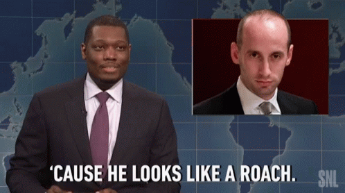 Man In Suit And Tie Says Roach GIF