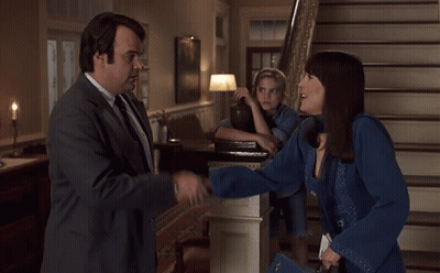Man In Suit And Tie Shakes Hands With Woman GIF
