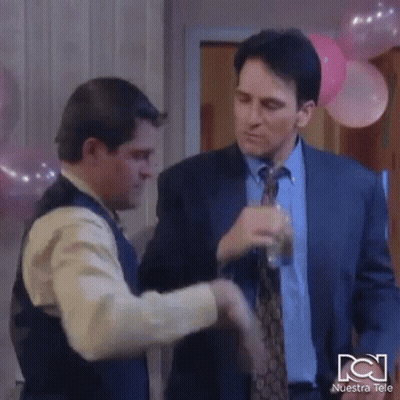 Man In Suit And Tie Shaking Hands With Man In Vest GIF